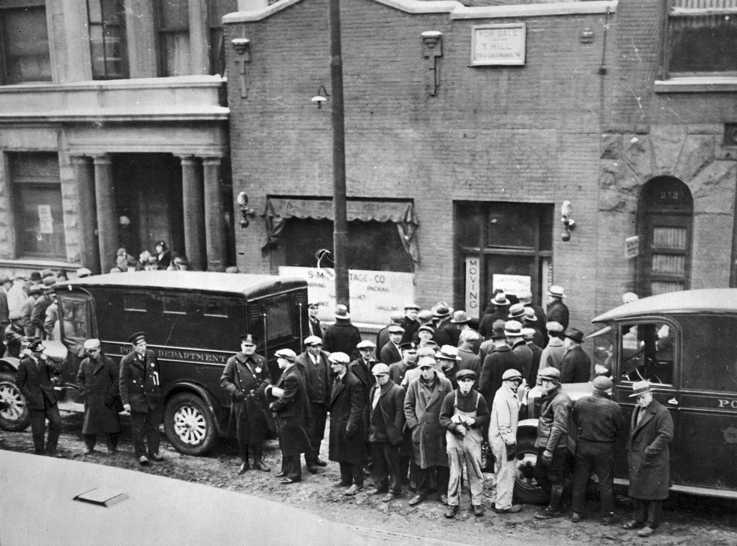 Crowd and policemen at the site of St. Valentine’s Day Massacre
