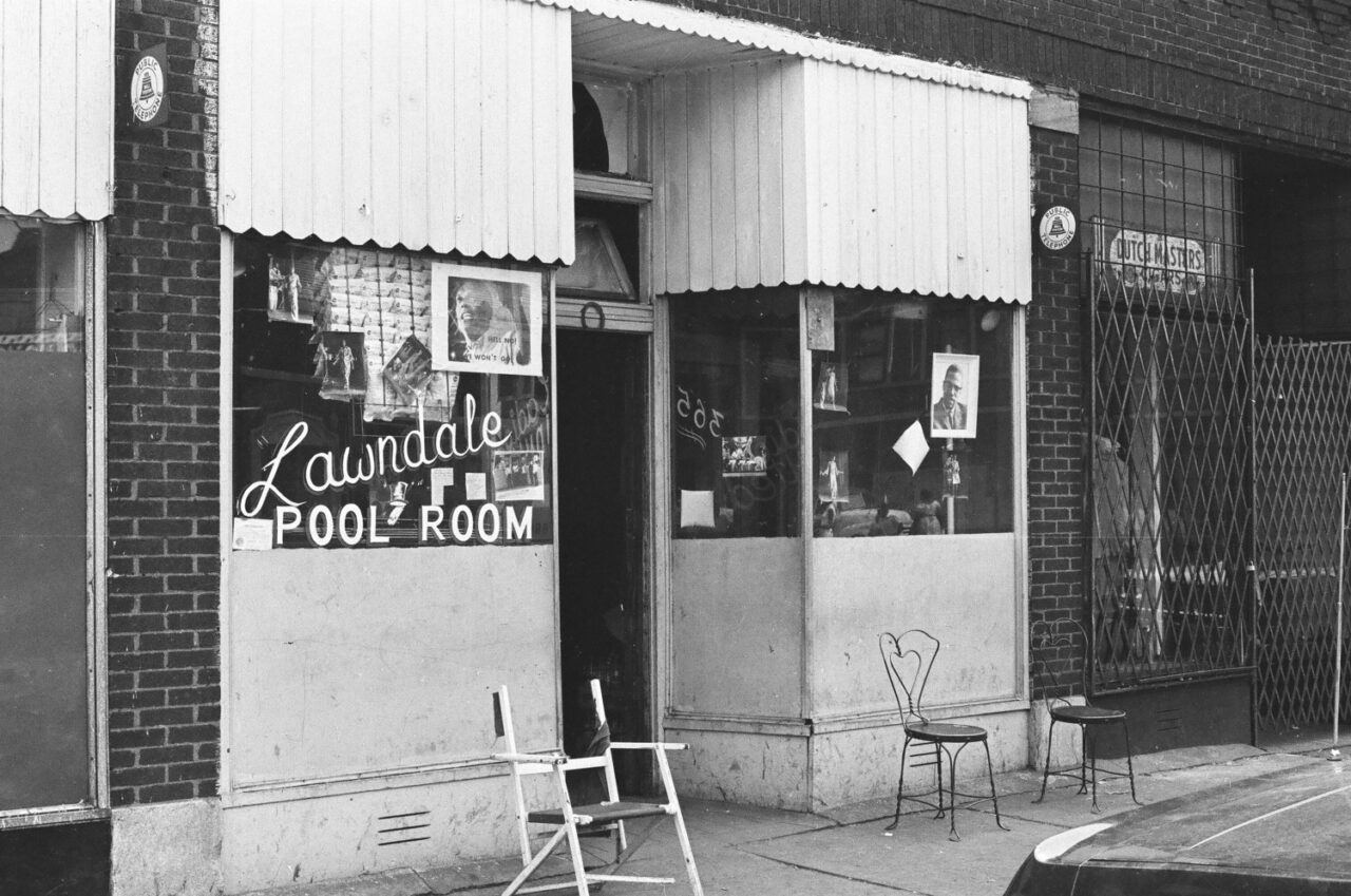 Leader of Conservative Vice Lord sitting outside pool room