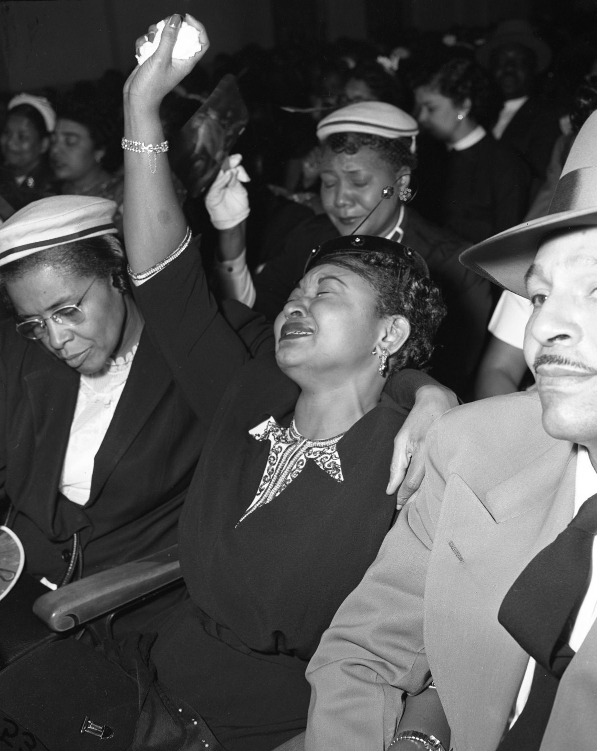 Mamie Bradley raises her hand during the funeral service of Emmett Till